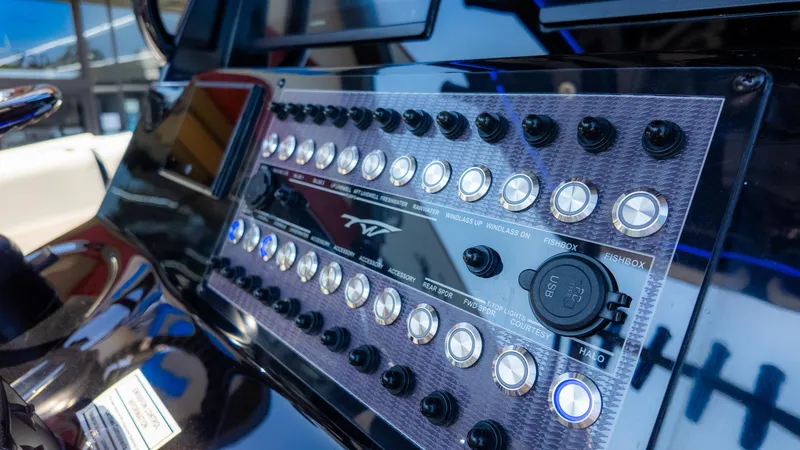 Slide: The Image of Control panel of 2025 Tidewater 320cc boat with buttons and USB port. - 20