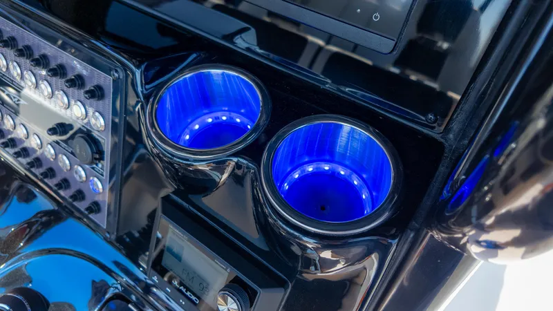 Slide: The Image of 2025 Tidewater 320cc boat console with illuminated cup holders and control panel. - 21