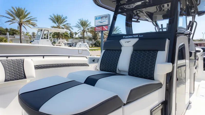 Slide: The Image of 2025 Tidewater 320cc boat with luxurious seating, displayed at Bluewater Marine. - 25