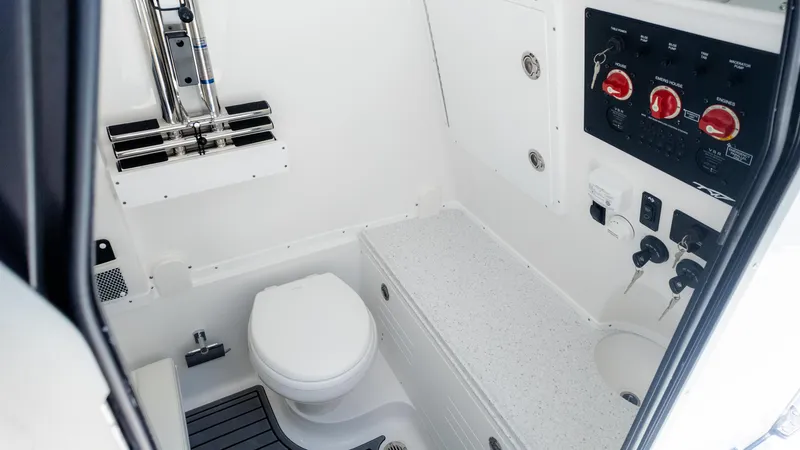 Slide: The Image of 2025 Tidewater 320cc boat interior with toilet and control panel. - 27