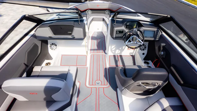 Slide: The Image of 2024 Cobalt CS23 Surf boat interior with modern dashboard and seating. - 11