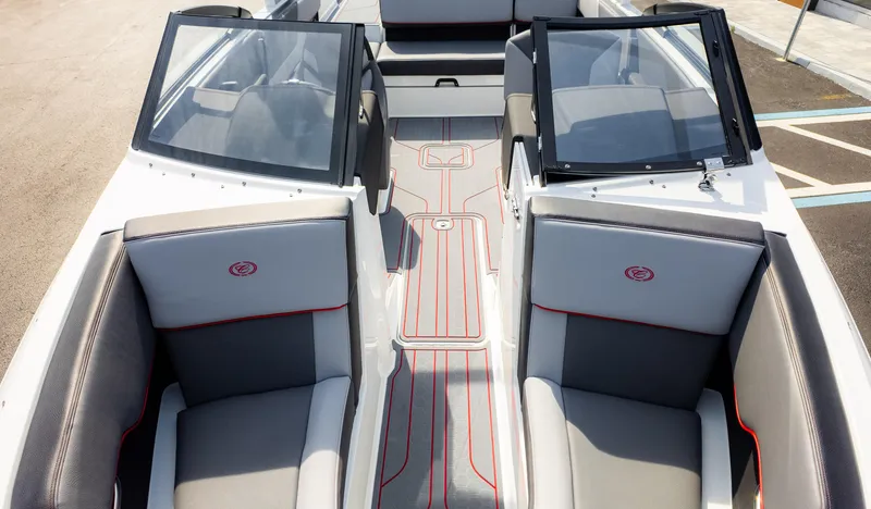 Slide: The Image of 2024 Cobalt CS23 Surf boat interior with gray seating and red accents. - 13