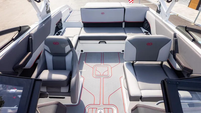 Slide: The Image of 2024 Cobalt CS23 Surf boat interior with gray seating and red accents. - 14