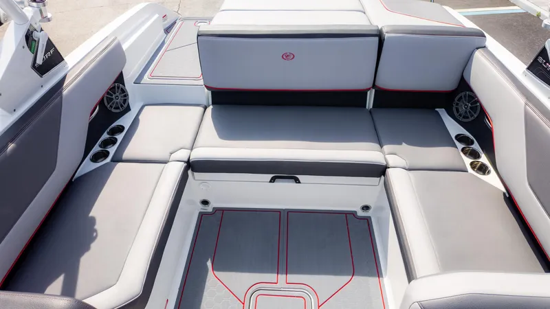 Slide: The Image of 2024 Cobalt CS23 Surf boat interior with gray seating and cup holders. - 15