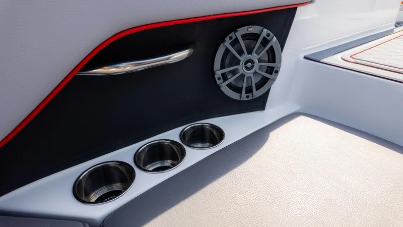 Slide: The Image of 2024 Cobalt CS23 Surf boat interior with speaker and cup holders. - 23