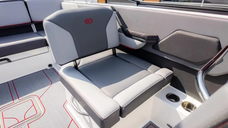 Slide: The Image of 2024 Cobalt CS23 Surf boat interior with gray seating and cup holders. - 28
