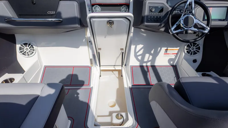 Slide: The Image of 2024 Cobalt CS23 Surf boat interior with steering wheel and storage compartment. - 31