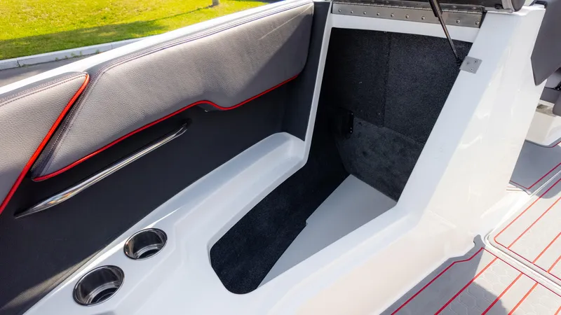 Slide: The Image of 2024 Cobalt CS23 Surf interior with sleek design, cup holders, and modern upholstery. - 36