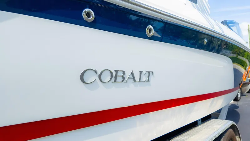 Slide: The Image of 2024 Cobalt CS23 Surf boat with sleek design and vibrant red stripe. - 4