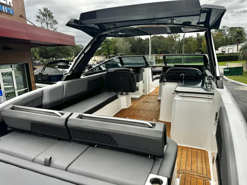 Slide: The Image of 2025 Cobalt R33 boat interior with sleek seating and wooden flooring. - 11