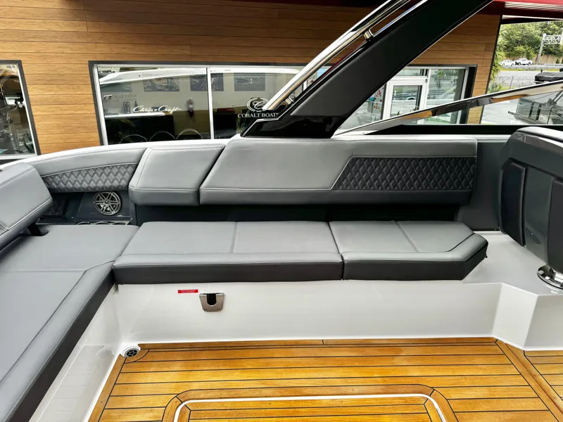 Slide: The Image of Luxurious interior of 2025 Cobalt R33 boat with sleek seating and wooden flooring. - 13