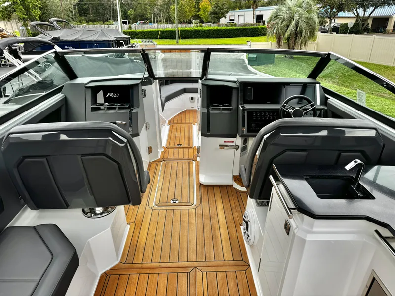 Slide: The Image of 2025 Cobalt R33 boat interior with sleek design, modern controls, and wood flooring. - 14