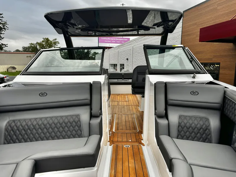 Slide: The Image of 2025 Cobalt R33 boat interior with luxurious seating and wooden flooring. - 24
