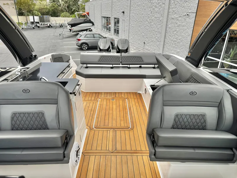 Slide: The Image of 2025 Cobalt R33 boat interior with luxurious seating and teak flooring. - 25