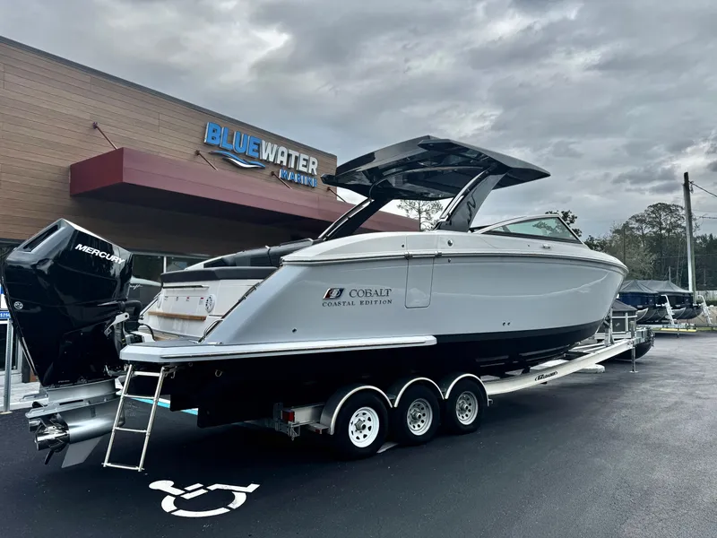 Slide: The Image of 2025 Cobalt R33 Coastal Edition boat on trailer at Bluewater Marine dealership. - 3