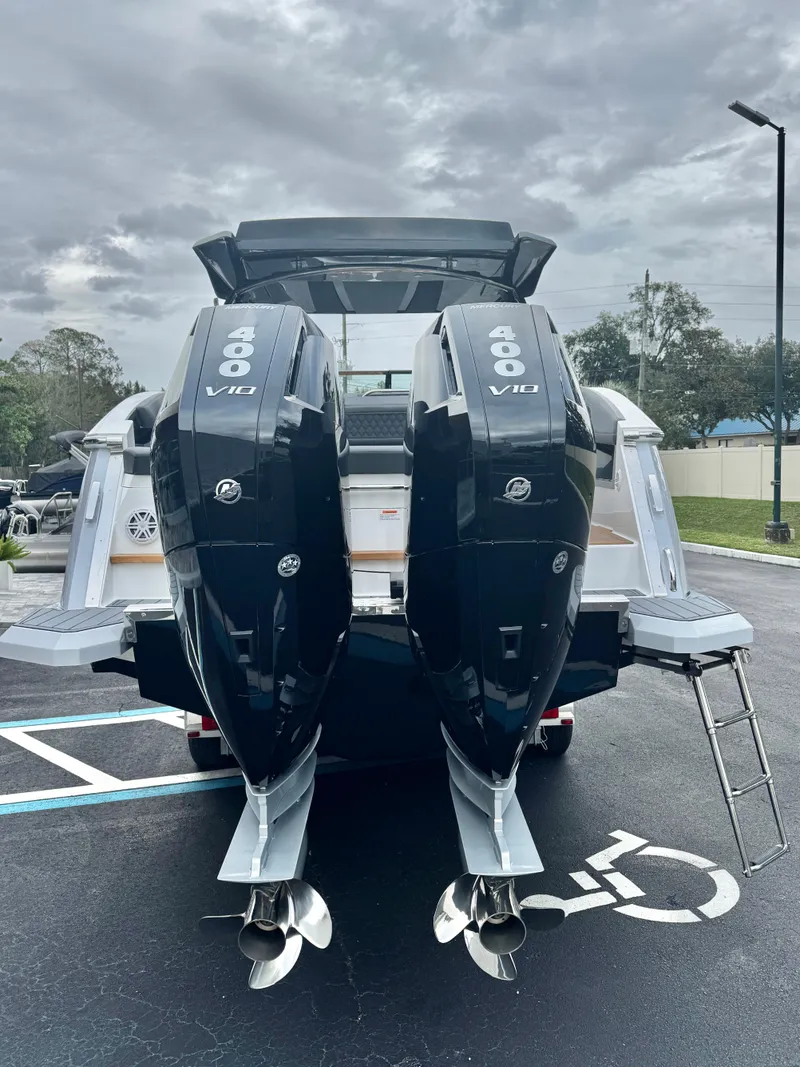 Slide: The Image of 2025 Cobalt R33 boat with dual 400 V10 outboard engines in a parking lot. - 4