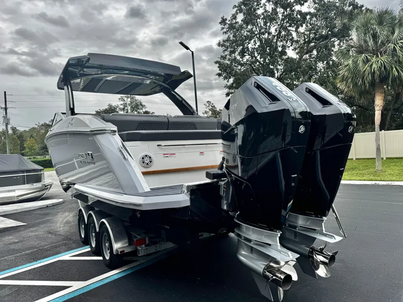 Slide: The Image of 2025 Cobalt R33 boat with dual outboard engines on a trailer, parked outdoors. - 5