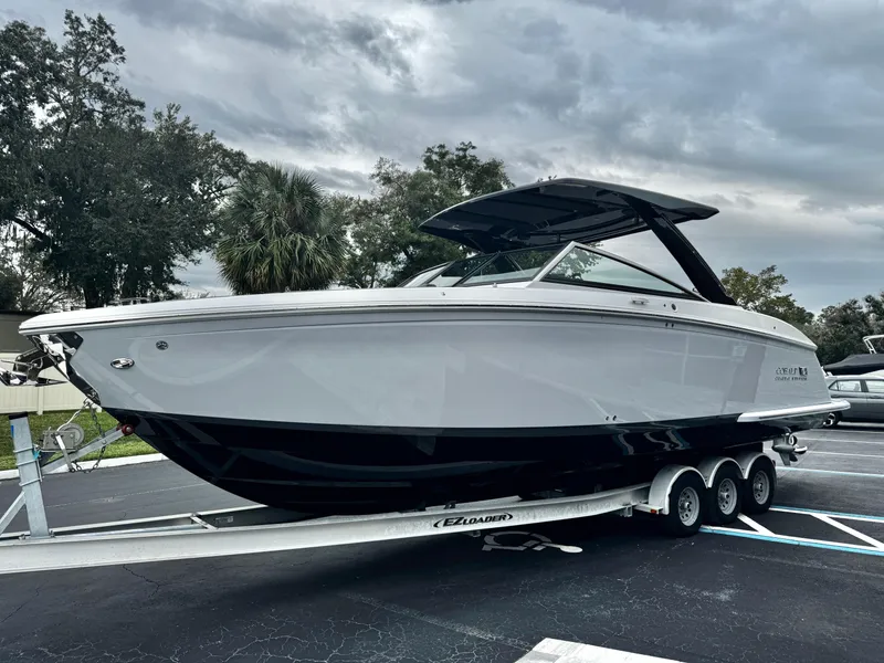 Slide: The Image of 2025 Cobalt R33 boat on trailer, sleek design, overcast sky background. - 6