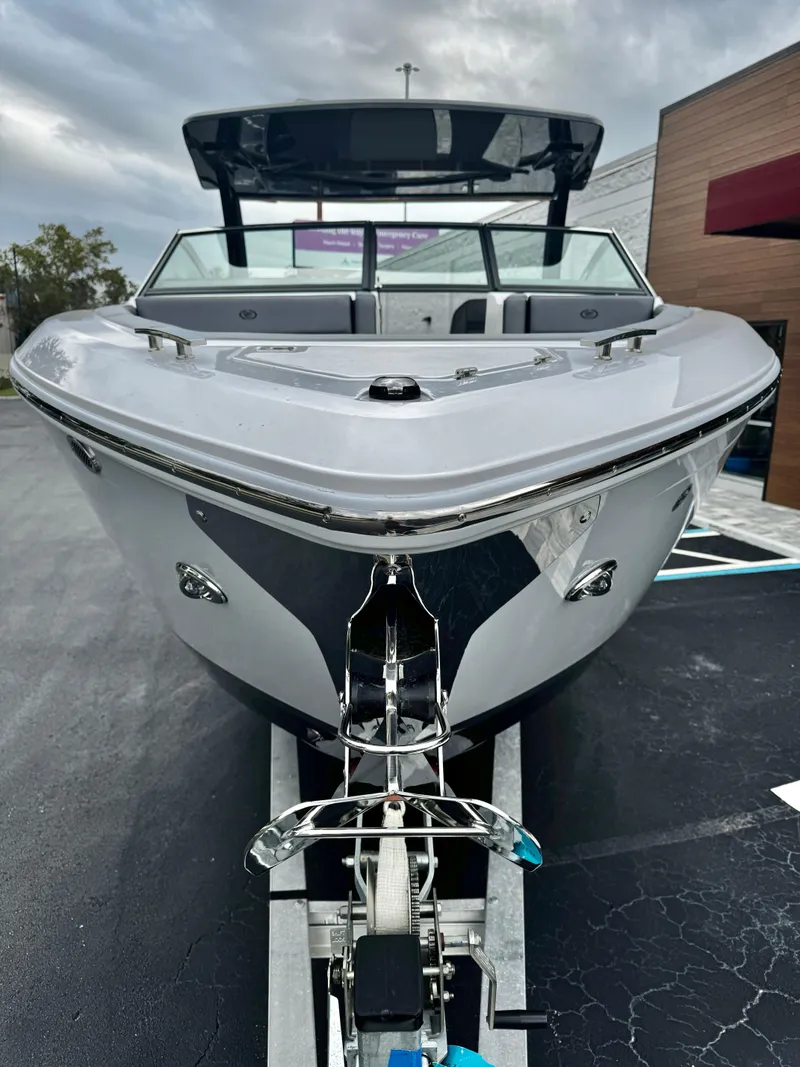 Slide: The Image of 2025 Cobalt R33 boat on trailer, front view, sleek design, overcast sky. - 7