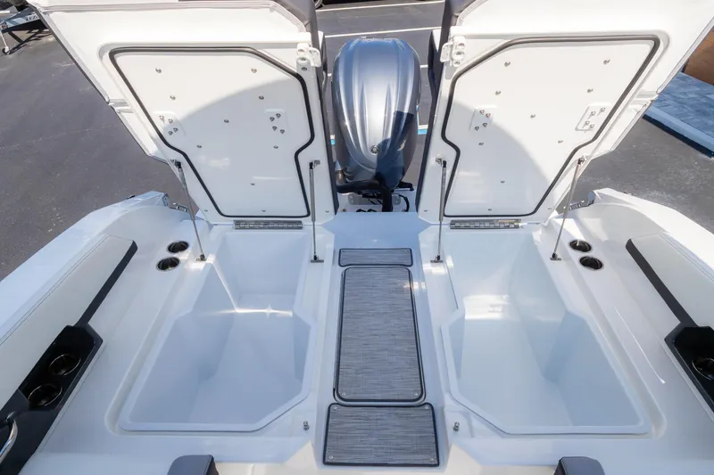 Slide: The Image of 2024 Cobalt R6 OB boat storage compartments with open hatches and sleek design. - 23