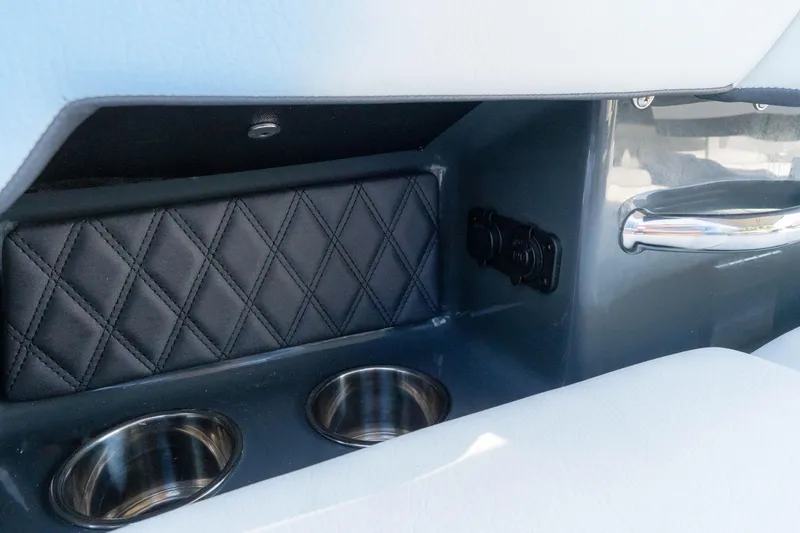 Slide: The Image of 2024 Cobalt R6 OB interior with cup holders and quilted paneling. - 24