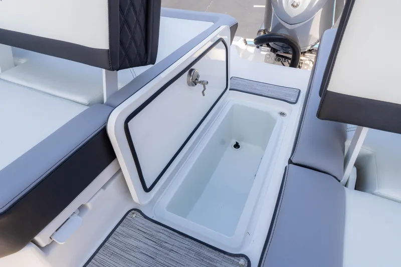 Slide: The Image of 2024 Cobalt R6 OB boat interior with open storage compartment and seating. - 25