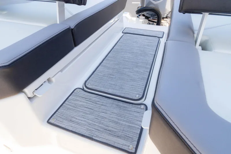 Slide: The Image of 2024 Cobalt R6 OB boat interior with cushioned seating and textured flooring. - 26