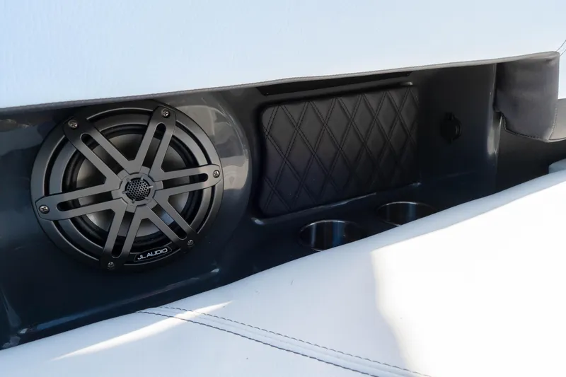 Slide: The Image of 2024 Cobalt R6 OB boat interior with JL Audio speaker and cup holders. - 30