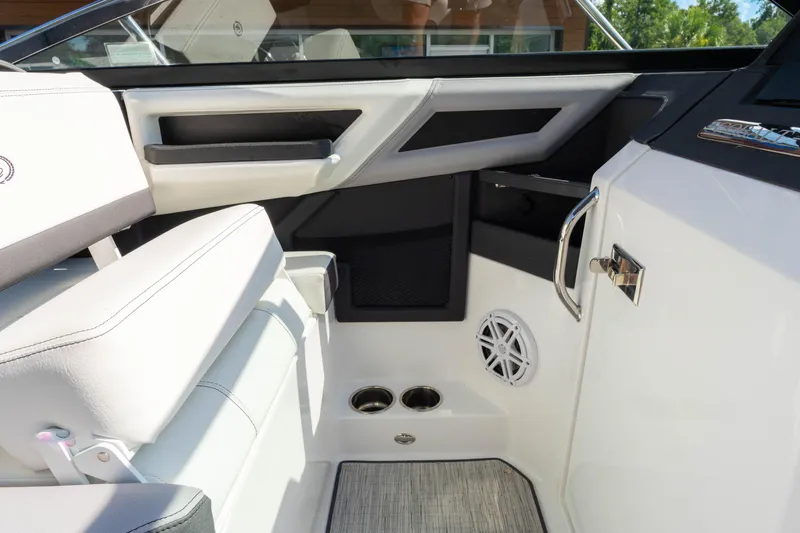 Slide: The Image of 2024 Cobalt R6 OB boat interior with white seating and modern design elements. - 34