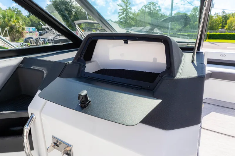Slide: The Image of 2024 Cobalt R6 OB boat interior dashboard with storage compartment. - 38
