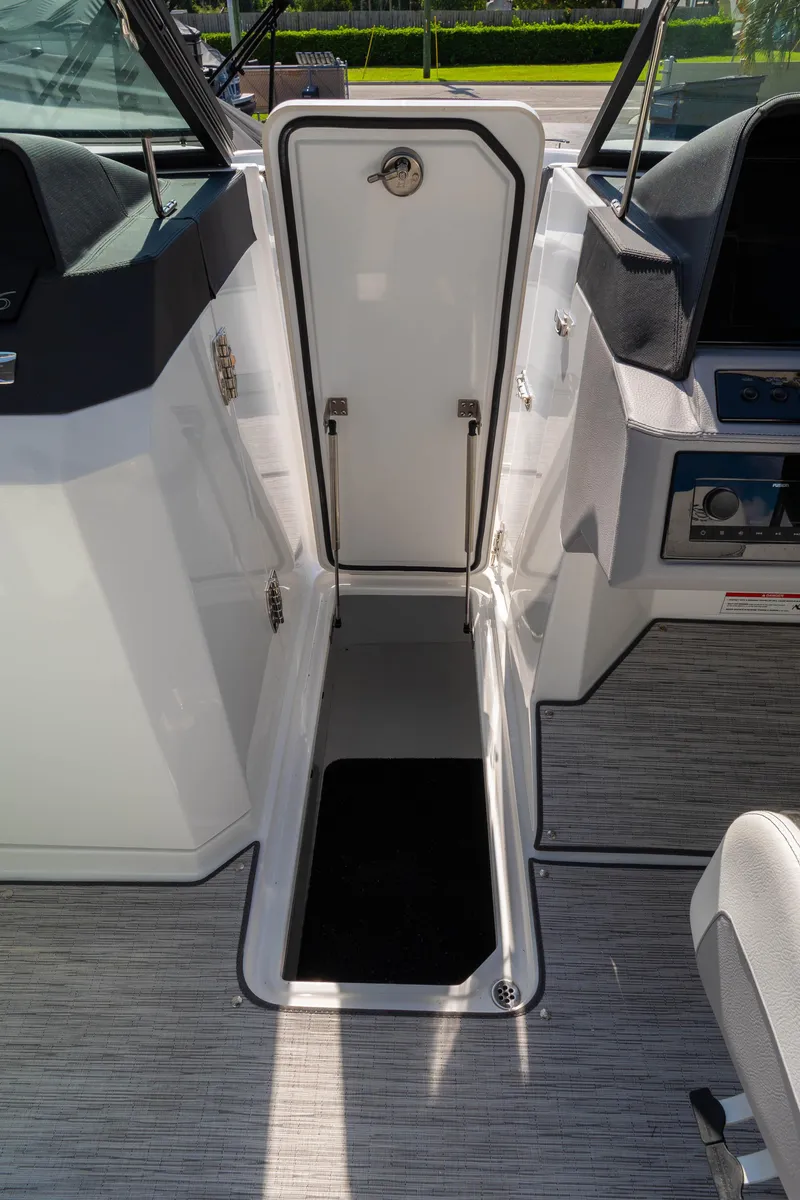 Slide: The Image of 2024 Cobalt R6 OB boat interior with open storage compartment and seating area. - 41