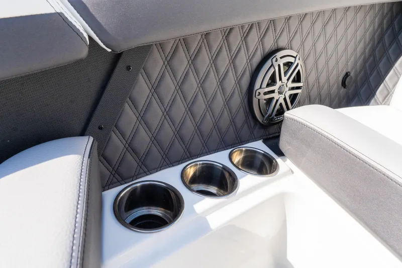 Slide: The Image of 2024 Cobalt R6 OB interior with quilted paneling, speaker, and cup holders. - 48