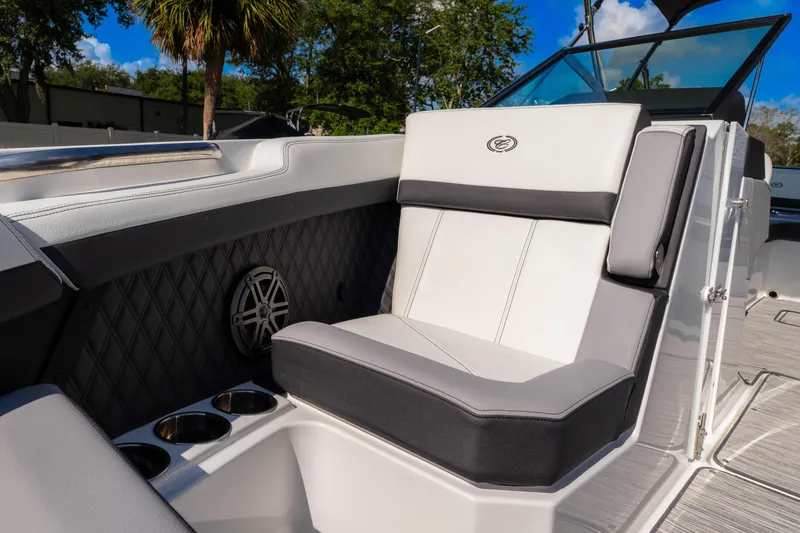 Slide: The Image of 2024 Cobalt R6 OB boat interior with luxurious seating and cup holders. - 49