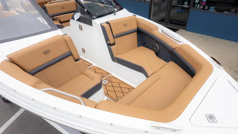 Slide: The Image of 2025 Cobalt R6OB boat interior with tan and gray seating, showcasing luxury design. - 10