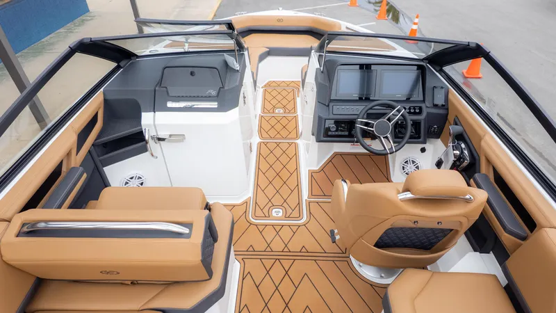 Slide: The Image of 2025 Cobalt R6OB boat interior with tan seating, modern dashboard, and sleek design. - 12