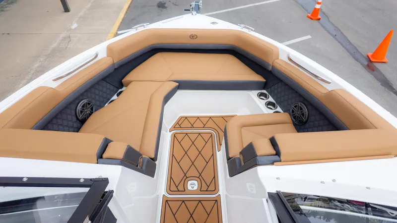 Slide: The Image of 2025 Cobalt R6OB boat interior with tan seating and diamond-pattern flooring. - 13