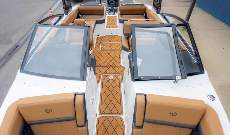 Slide: The Image of 2025 Cobalt R6OB boat interior with tan seating and open windshield design. - 14