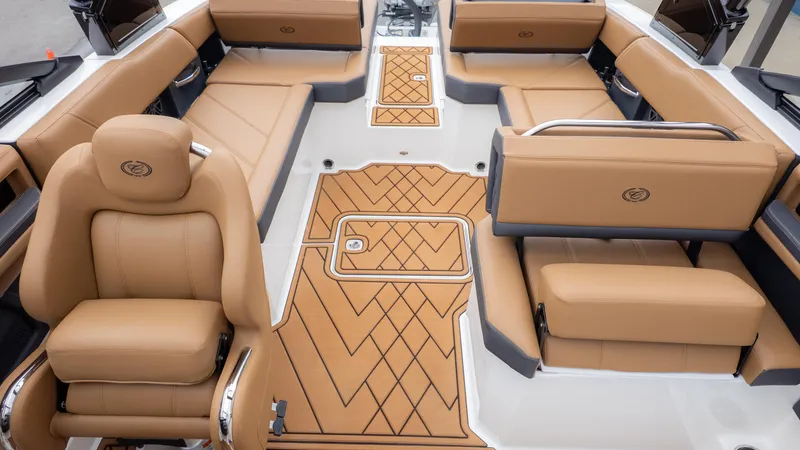 Slide: The Image of 2025 Cobalt R6OB boat interior with tan leather seating and stylish flooring. - 15