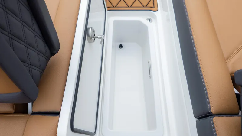 Slide: The Image of 2025 Cobalt R6OB boat interior storage compartment with tan and black seating. - 19
