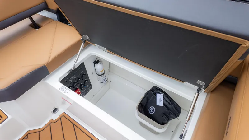 Slide: The Image of Storage compartment in 2025 Cobalt R6OB boat with safety equipment and controls. - 20