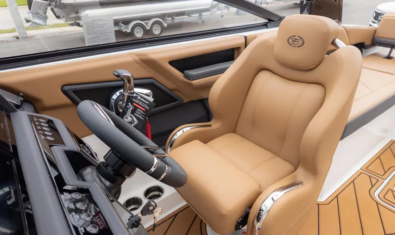 Slide: The Image of Luxurious interior of 2025 Cobalt R6OB boat with tan leather seating and modern controls. - 21