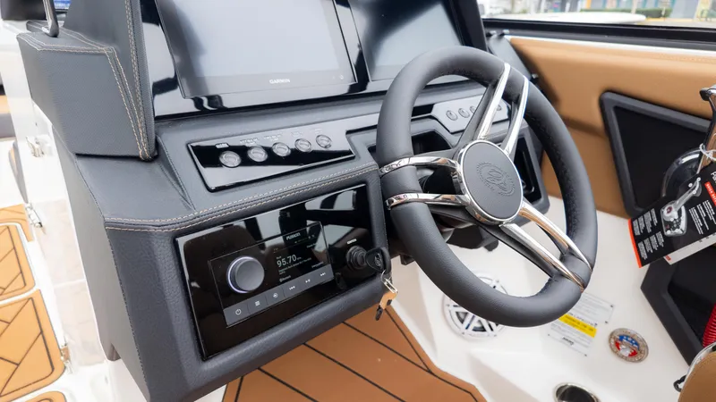 Slide: The Image of 2025 Cobalt R6OB boat dashboard with steering wheel and control panel. - 22