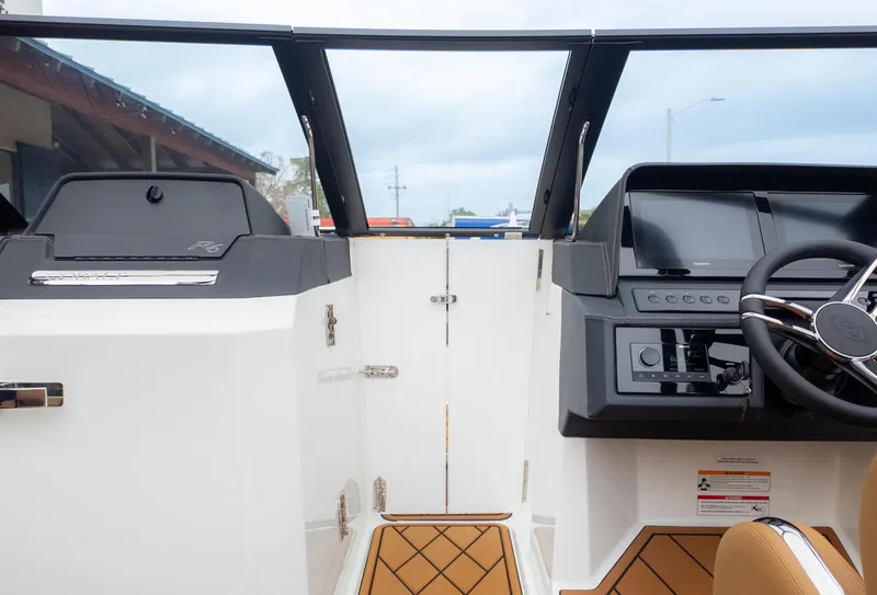 Slide: The Image of Interior view of 2025 Cobalt R6OB boat cockpit with modern dashboard and steering wheel. - 25