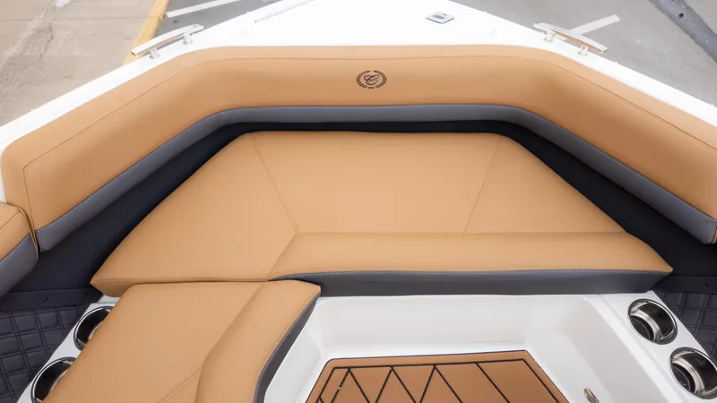 Slide: The Image of 2025 Cobalt R6OB boat interior with tan leather seating and cup holders. - 28