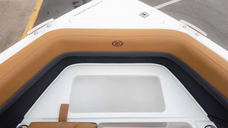 Slide: The Image of 2025 Cobalt R6OB boat interior with tan and black seating. - 30