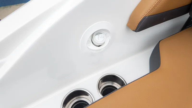 Slide: The Image of Interior of 2025 Cobalt R6OB boat with cup holders and tan seating. - 37