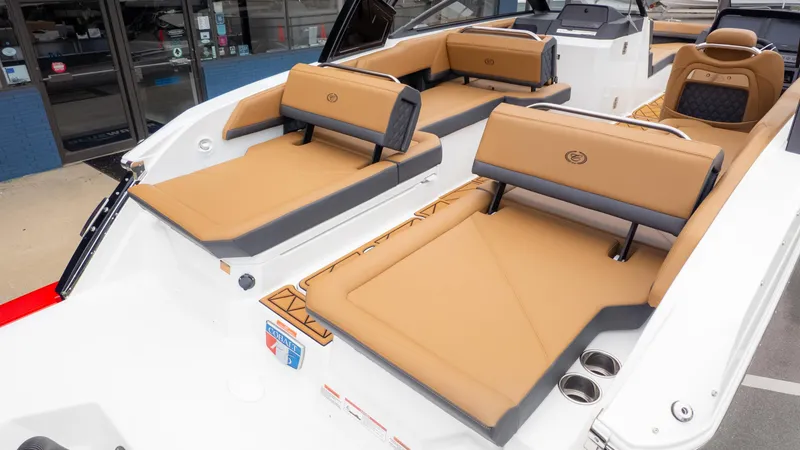 Slide: The Image of 2025 Cobalt R6OB boat interior with tan and black seating, showcasing luxury design. - 7