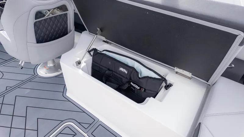Slide: The Image of 2025 Cobalt R6OB boat storage compartment with cushioned seating and sleek interior design. - 17