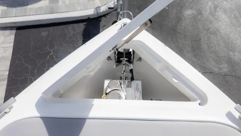 Slide: The Image of 2025 Cobalt R6OB boat anchor compartment, open lid, showcasing modern design and functionality. - 27