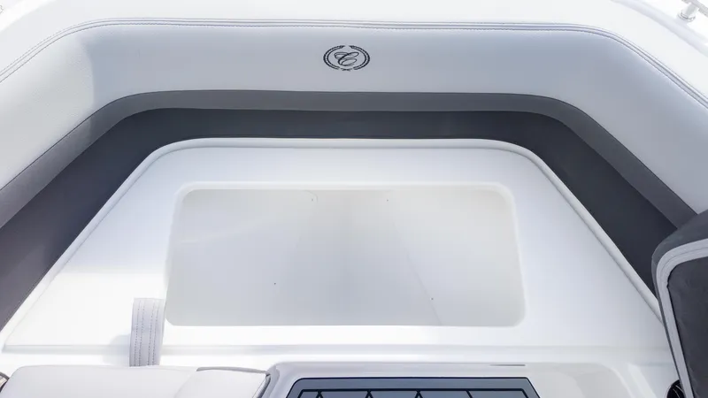 Slide: The Image of 2025 Cobalt R6OB boat interior with cushioned seating and storage compartment. - 28